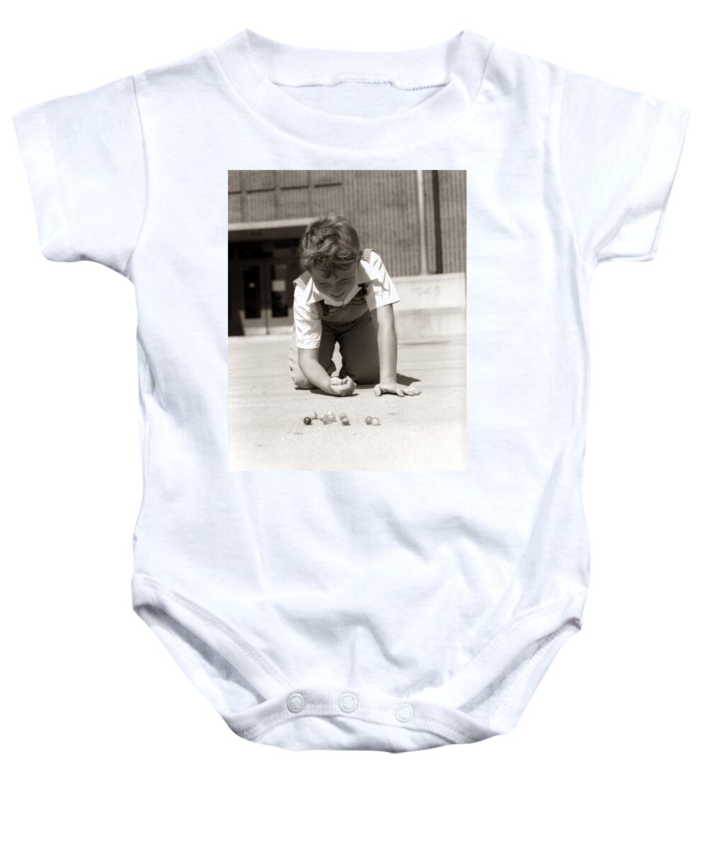 1950s Baby Onesie featuring the photograph Boy Playing Marbles, C.1950s by H. Armstrong Roberts/ClassicStock