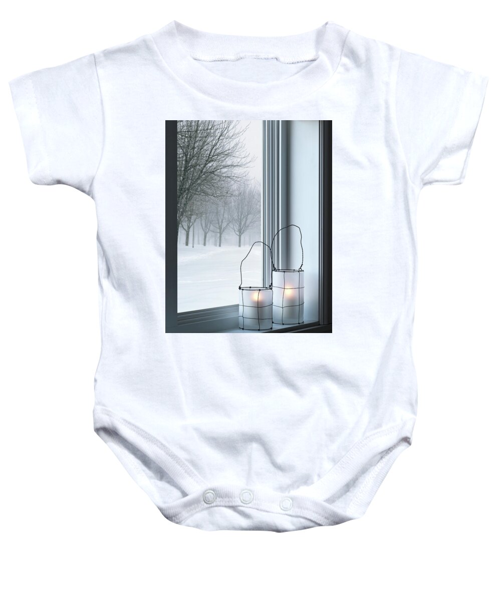 Lantern Baby Onesie featuring the photograph Cozy lanterns and winter landscape seen through the window by GoodMood Art