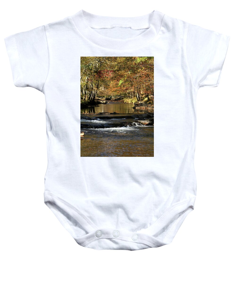 Water Baby Onesie featuring the photograph Creek water flowing through woods in autumn by Emanuel Tanjala