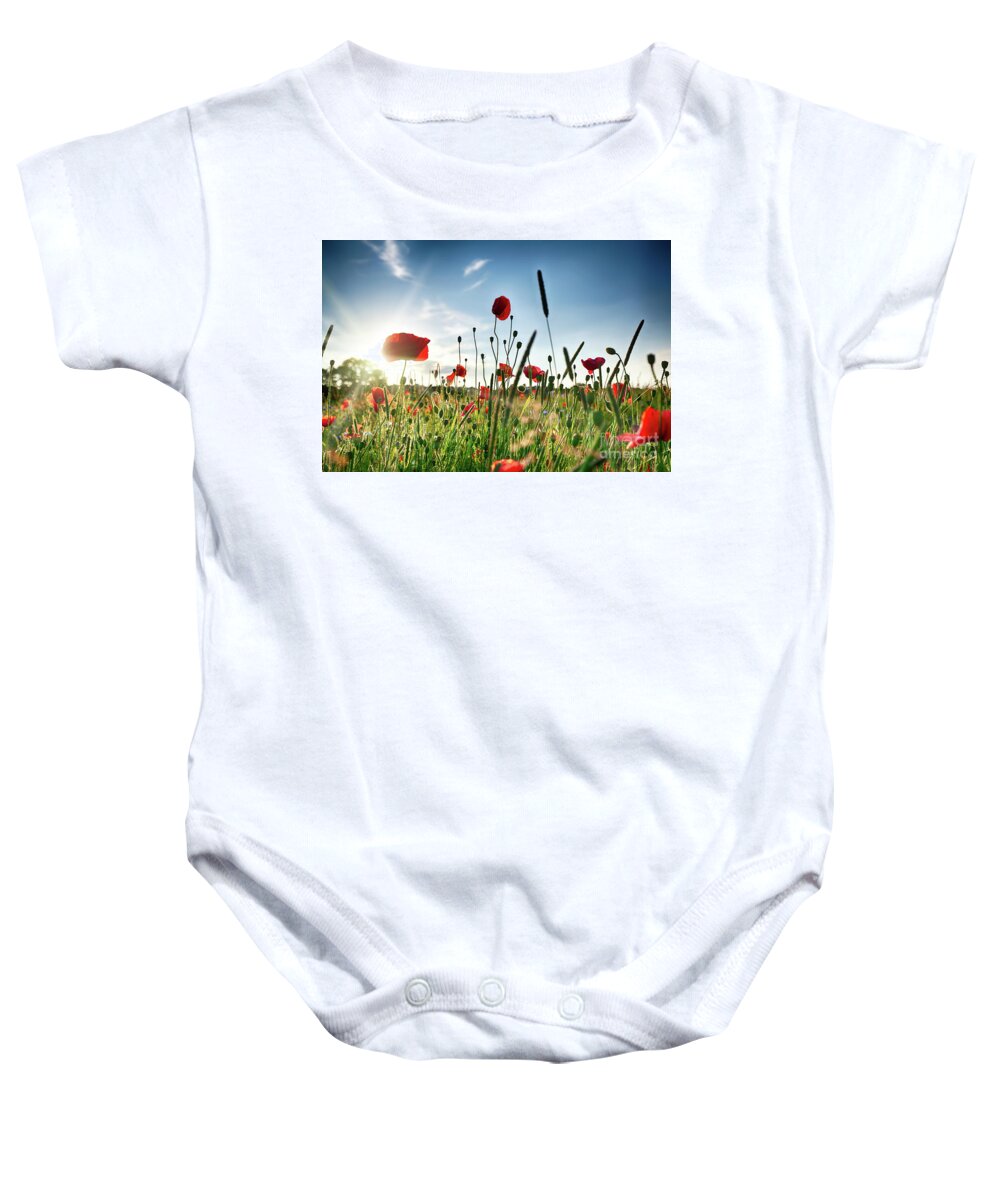 Field Baby Onesie featuring the photograph Fresh poppy field in sunlight by Simon Bratt