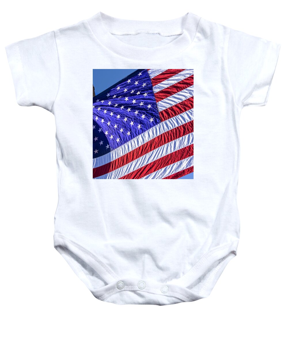 Flag Baby Onesie featuring the photograph Large Vibrant Hanging Flag by Phil Cardamone