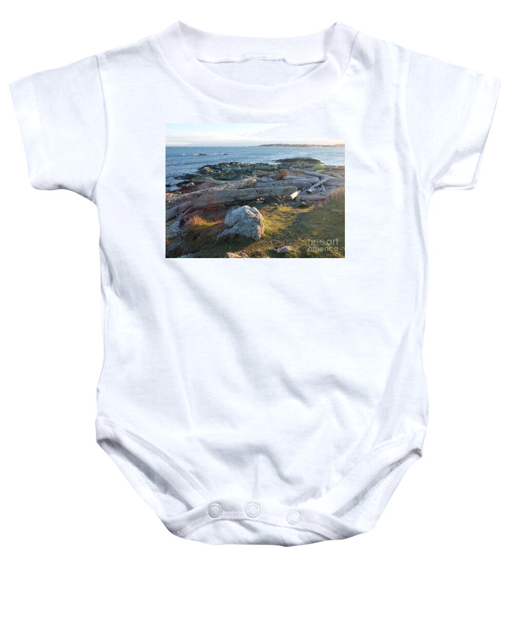 It Was Late Afternoon Standing Out By Cattle Loop Point In Victoria Bc. We Had Just Finished With The Windstorms And Arctic Outflows Leaving Behind Lots For Crafters And Artists To Peruse Through On The Beaches. Baby Onesie featuring the photograph Late In The Day by Ida Eriksen