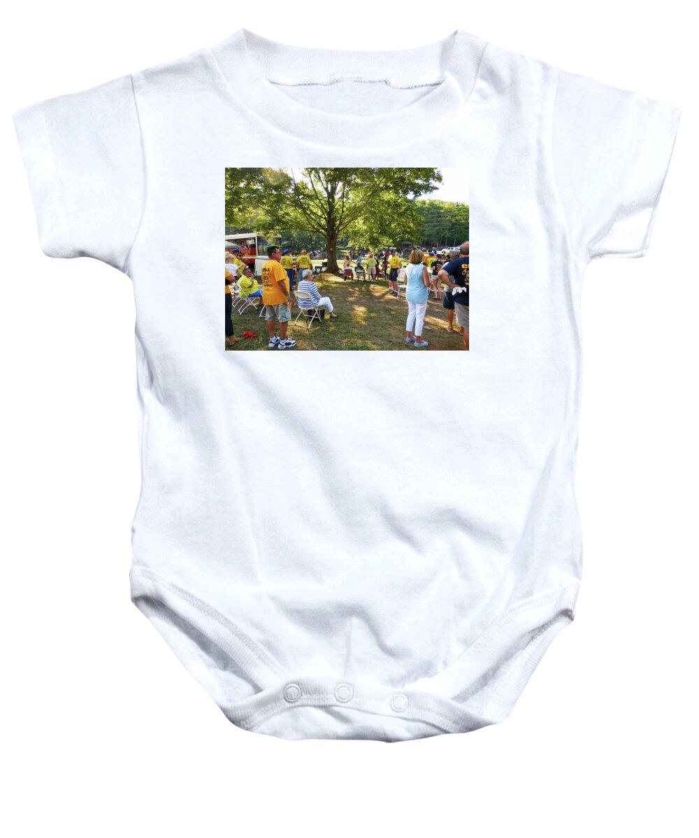 People Baby Onesie featuring the painting People gathered along the road with their lawn chairs 4 by Jeelan Clark