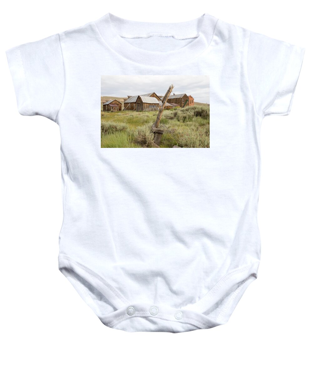 Abandoned Baby Onesie featuring the photograph Rustic wooden structures in Bodie, California by Karen Foley