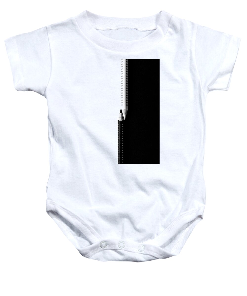 Pencil Baby Onesie featuring the photograph Two drawing pencils on a black and white surface. by Michalakis Ppalis