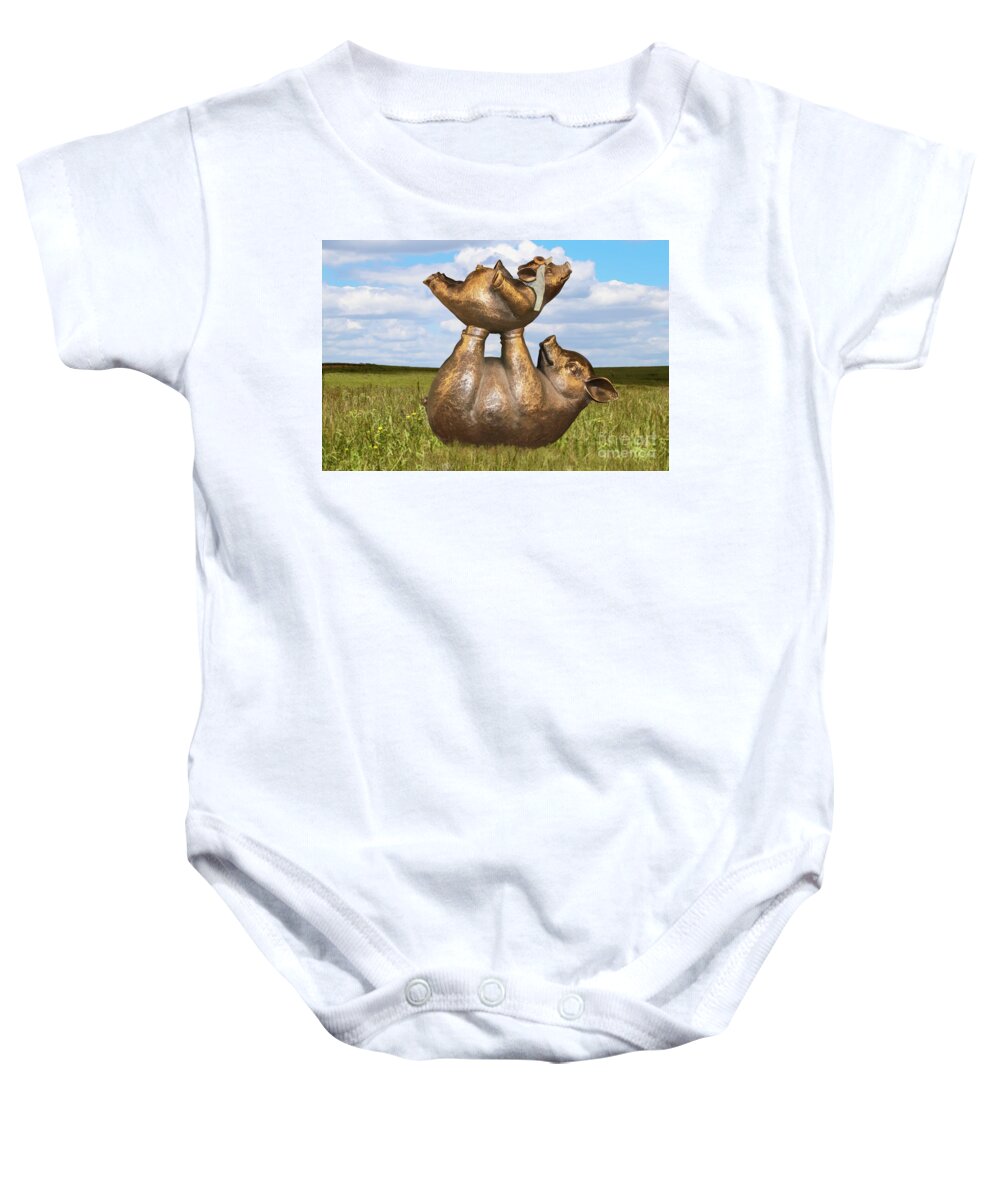 Pigs In Clover Baby Onesie featuring the digital art Teaching a pig to fly - mother pig in grassy field holds up baby pig with flying helmet to teach it by Susan Vineyard