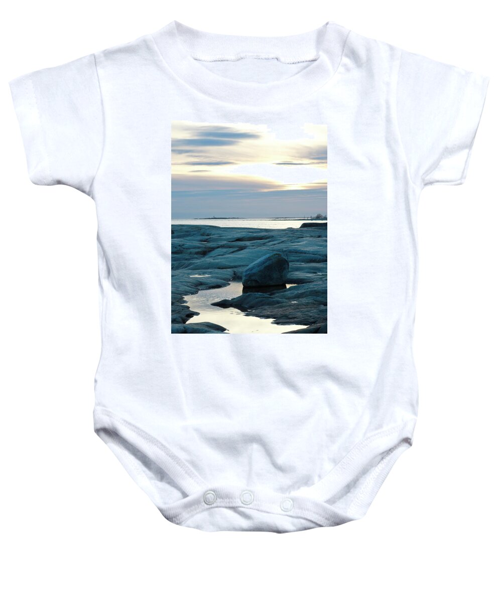 Baltic Sea Baby Onesie featuring the photograph A lighthouse is standing on a tiny island far out in the ocean, seen from the shore by Ulrich Kunst And Bettina Scheidulin