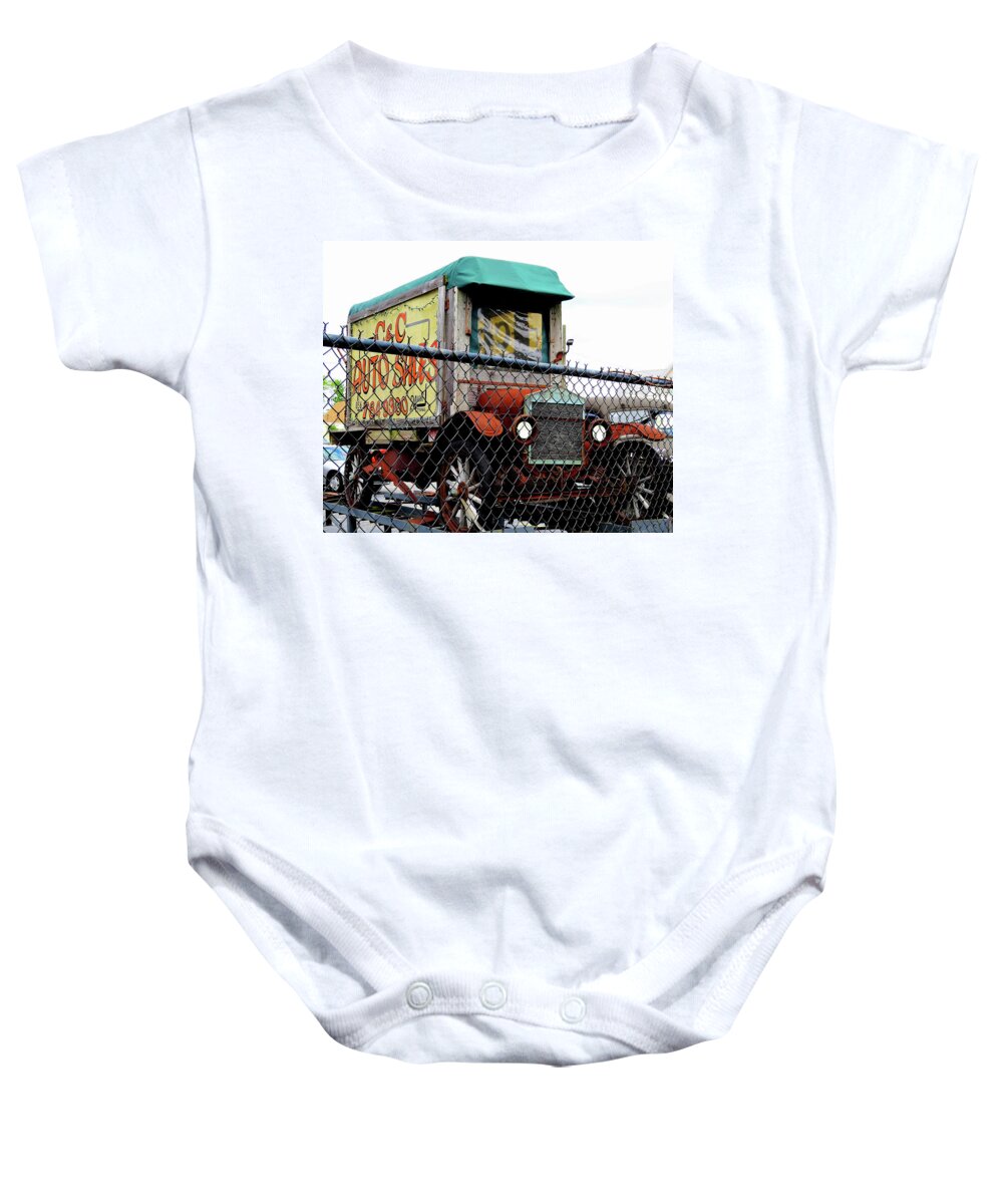 Antique Trucks Baby Onesie featuring the photograph Antique Truck Advertising Sign for Classic Auto Sales Lot by Linda Stern