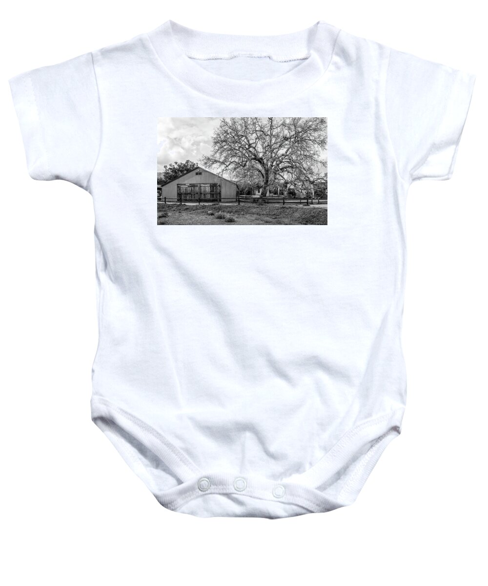 Old West Baby Onesie featuring the photograph The Livery Stable And Oak by Gene Parks