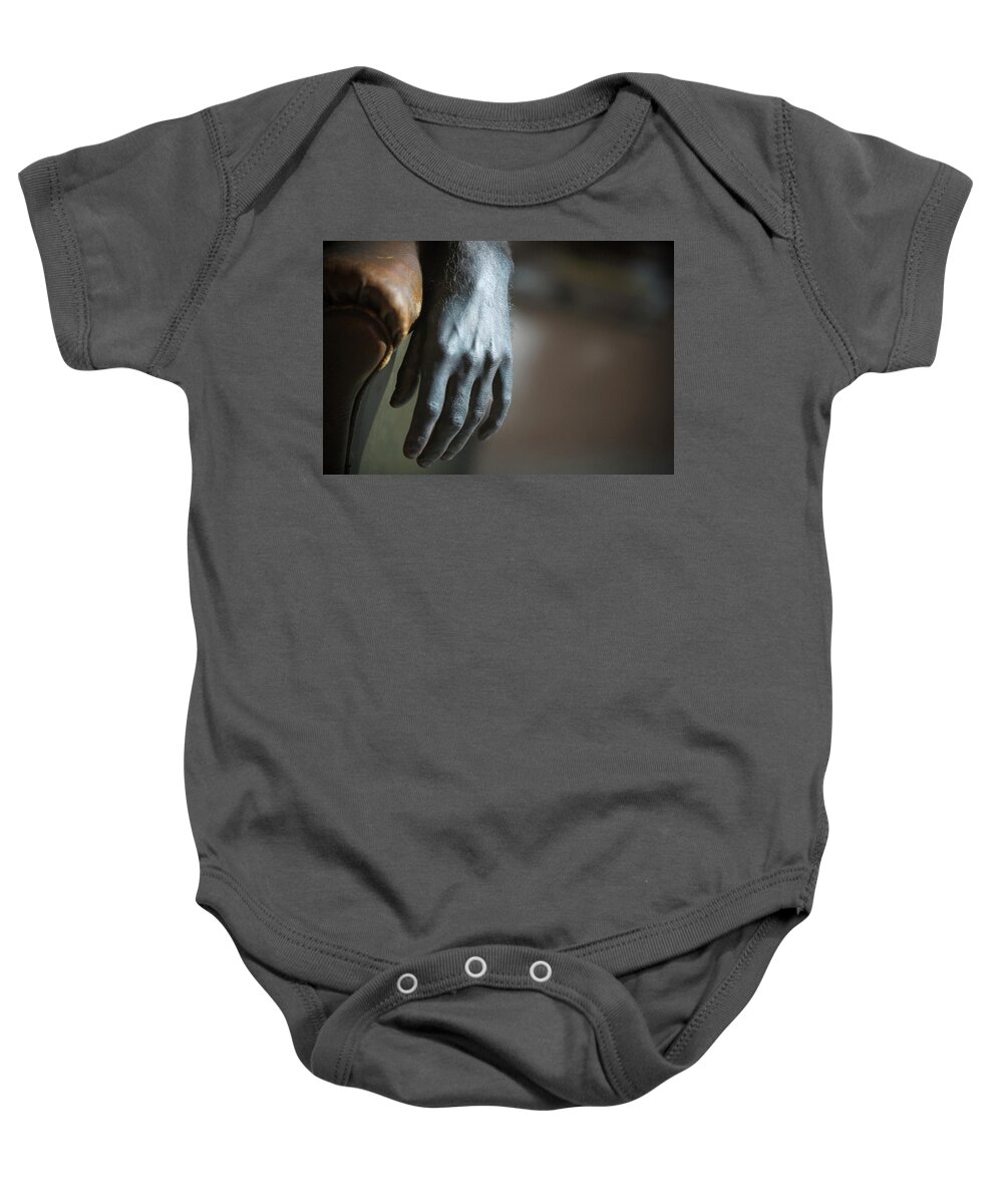 Armrest Baby Onesie featuring the photograph A Hand Laying On Armrest #1 by Ron Koeberer
