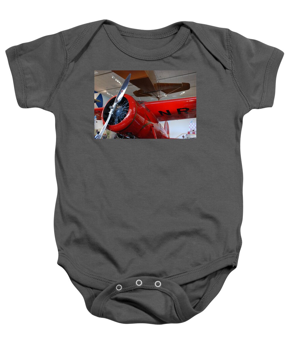 Amelia Earhart Baby Onesie featuring the photograph Amelia Earhart Prop Plane by Kenny Glover