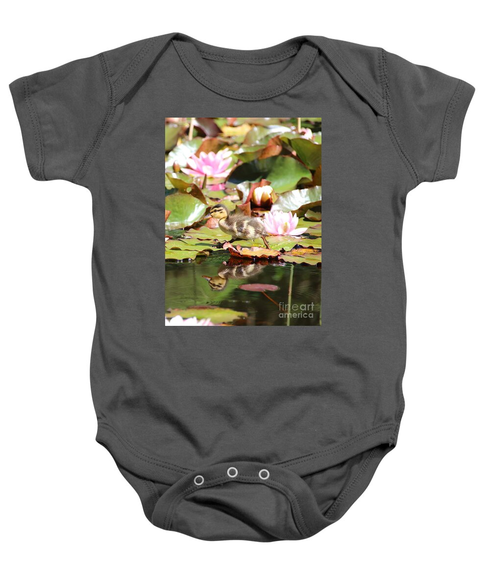 Ducklings Baby Onesie featuring the photograph Duckling running over the Water Lilies 2 by Amanda Mohler