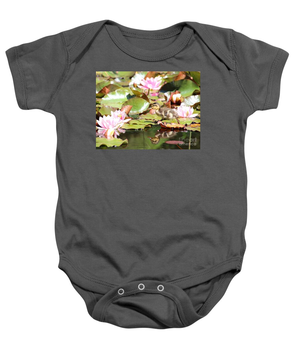 Ducklings Baby Onesie featuring the photograph Duckling running over the Water Lilies by Amanda Mohler