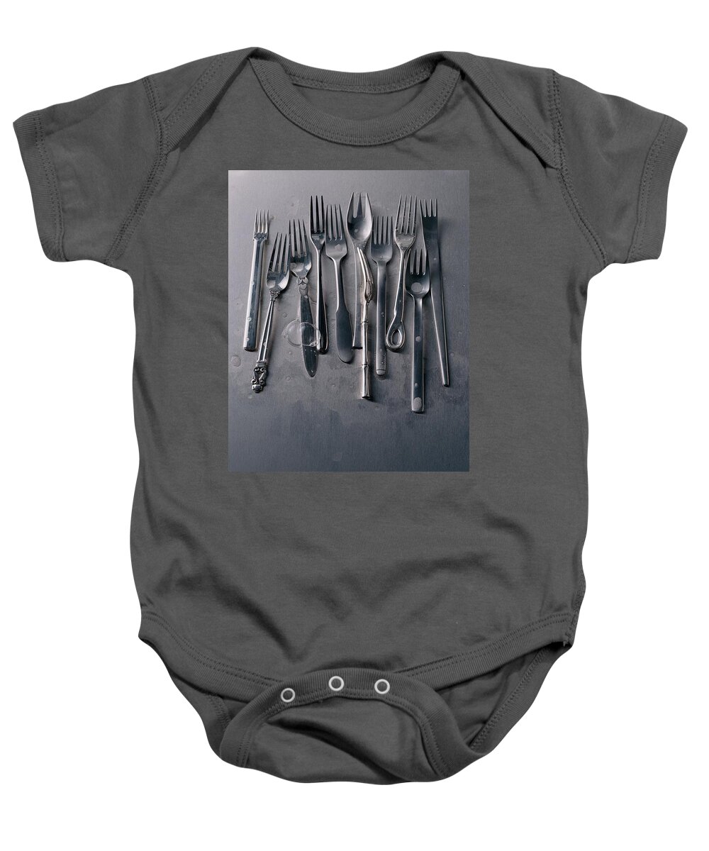 Kitchen Baby Onesie featuring the photograph Group Of Clean Forks by Romulo Yanes
