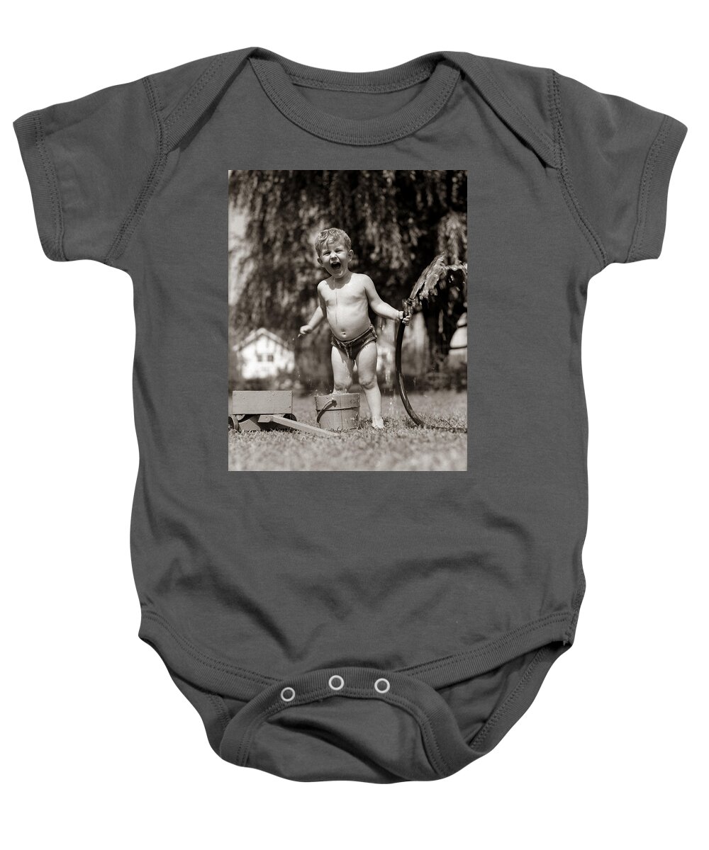 1940s Baby Onesie featuring the photograph Little Boy Playing With Hose, C.1940-50s by H. Armstrong Roberts/ClassicStock