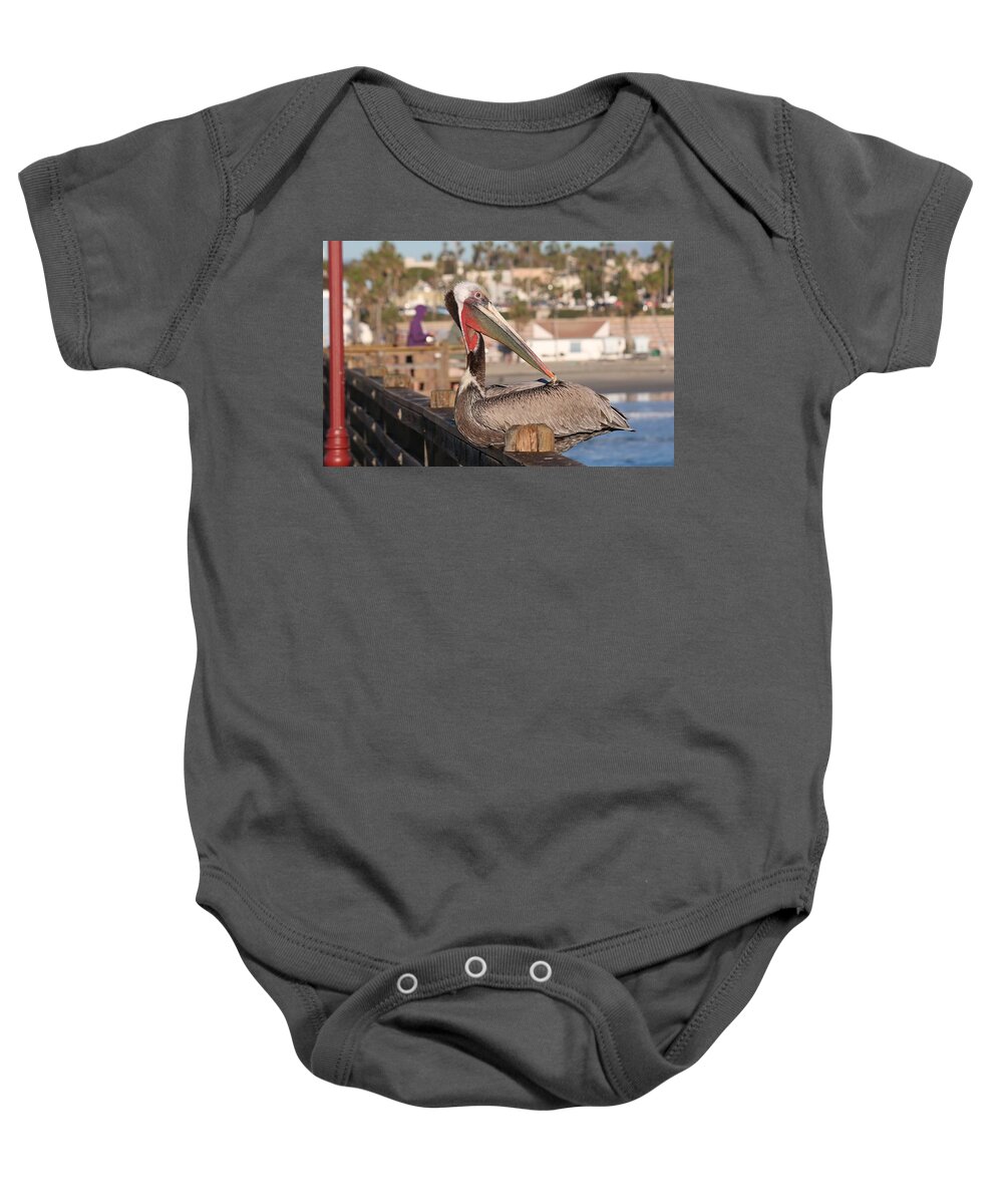 Wild Baby Onesie featuring the photograph Pelican Sitting on Pier by Christy Pooschke