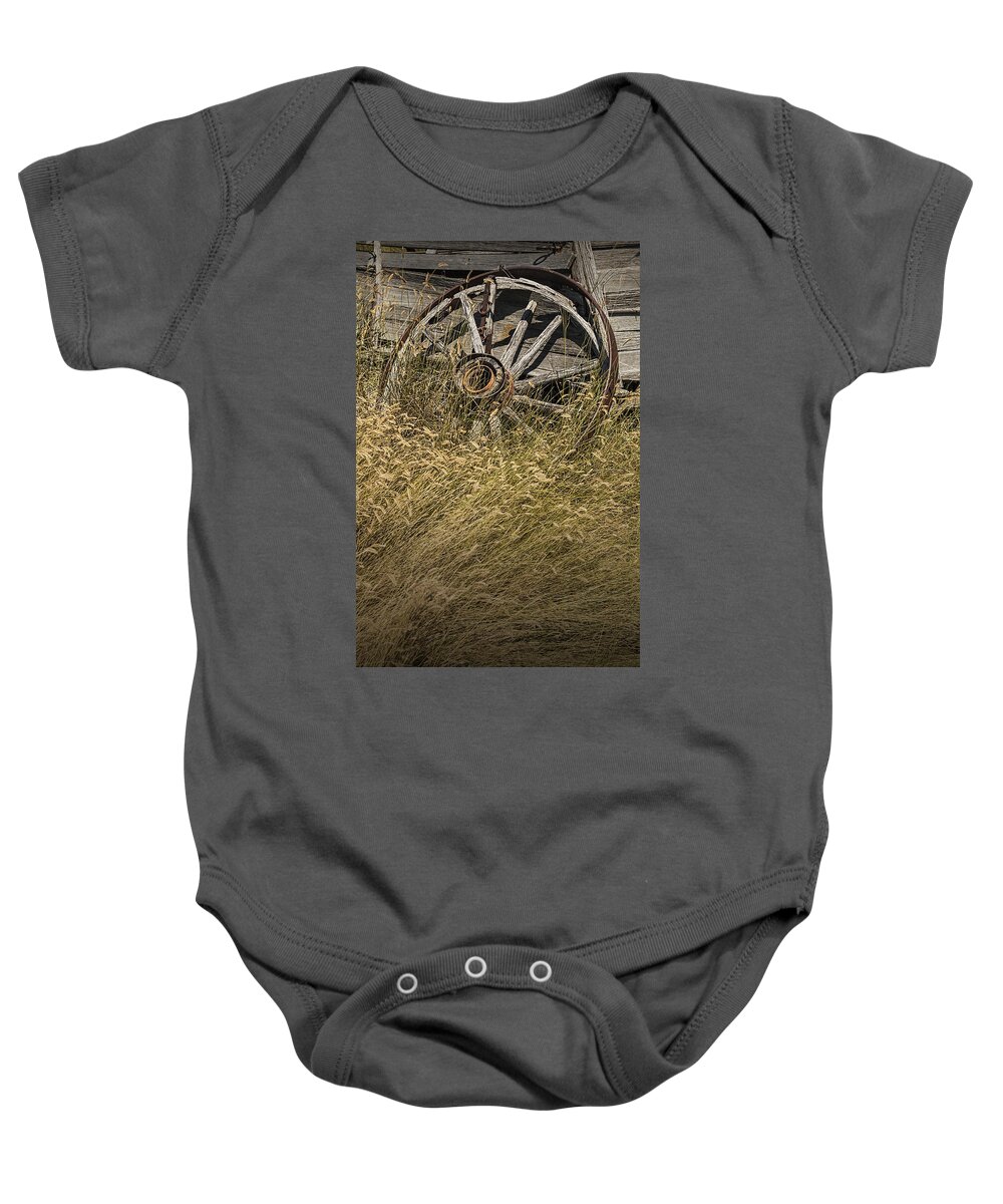 Art Baby Onesie featuring the photograph Wooden Wheel of a Broken Farm Wagon by Randall Nyhof