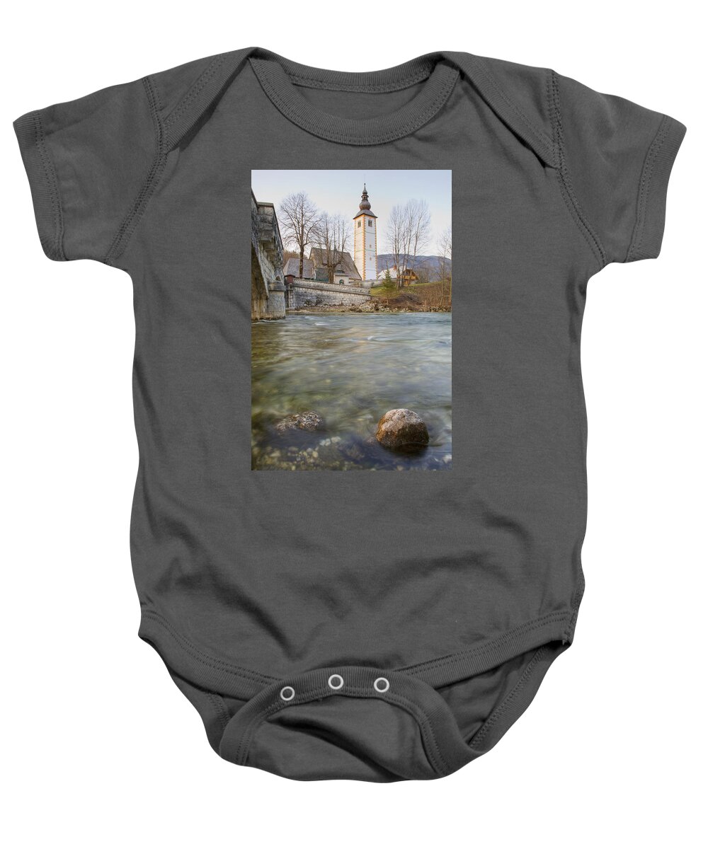 Travel Baby Onesie featuring the photograph Lake Bohinj as it flows under the bridge by Ian Middleton
