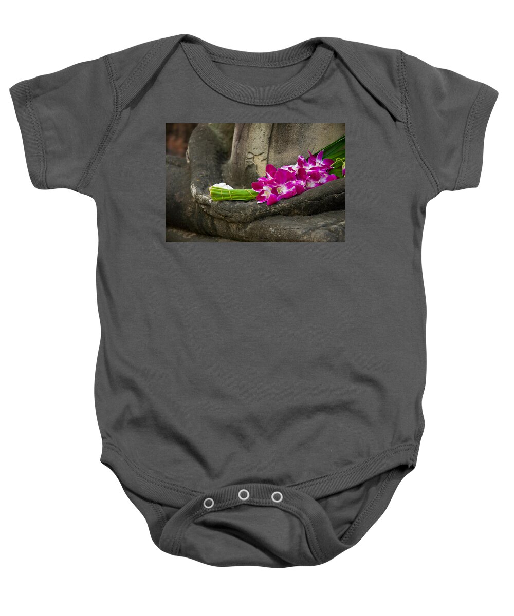 Ancient Baby Onesie featuring the photograph Sitting Buddha in meditation position with fresh Orchid flowers by U Schade