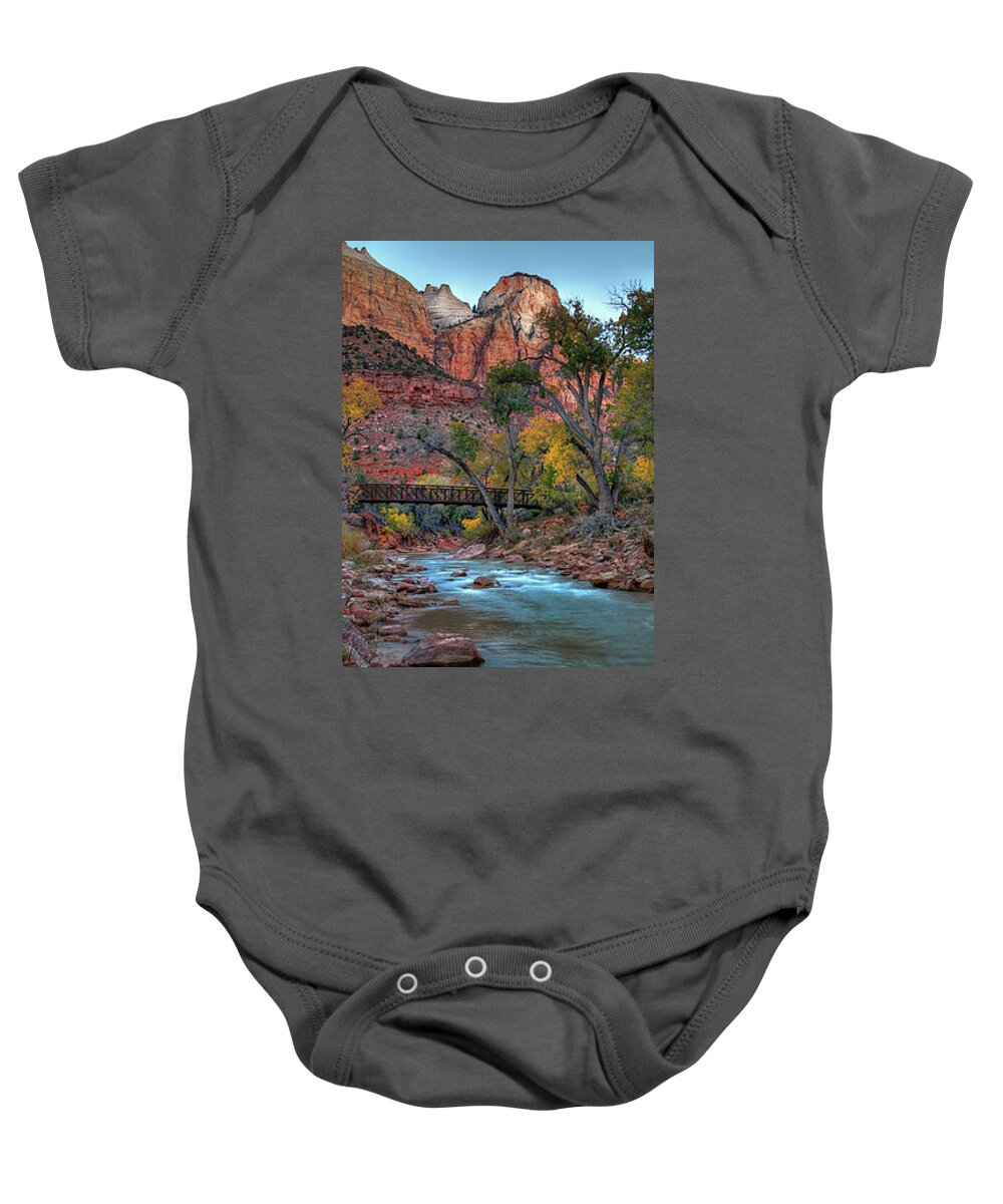The Waters Of The Virgin River Flow Beneath A Foot Bridge Amidst Autumn Colored Cottonwoods And Towering Red Cliffs. Baby Onesie featuring the photograph Zion National Park #22 by Douglas Pulsipher