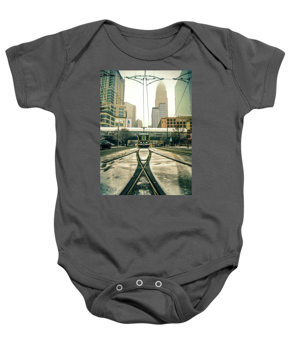 Streetcar Baby Onesie featuring the photograph Streetcar Waiting For Passengers In Snowstrom In Uptown Charlott #3 by Alex Grichenko