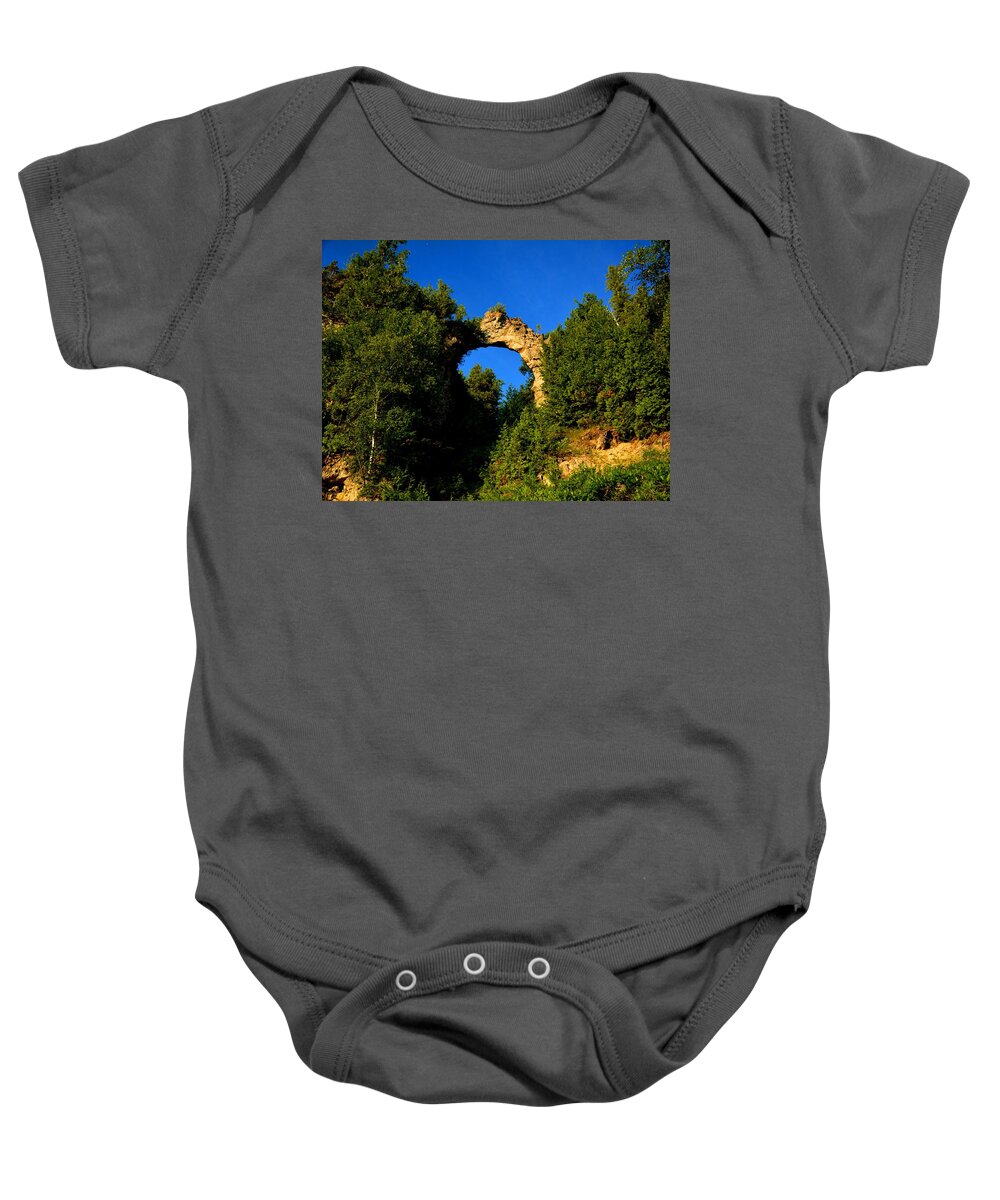 Mackinac Island Baby Onesie featuring the photograph Beneath Arch Rock by Keith Stokes