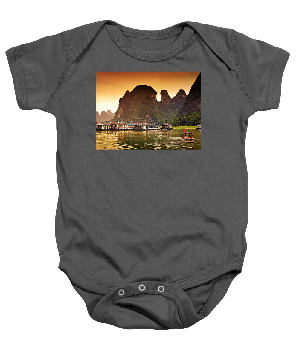 Sunset Baby Onesie featuring the photograph Boats by the river return-China Guilin scenery Lijiang River in Yangshuo by Artto Pan