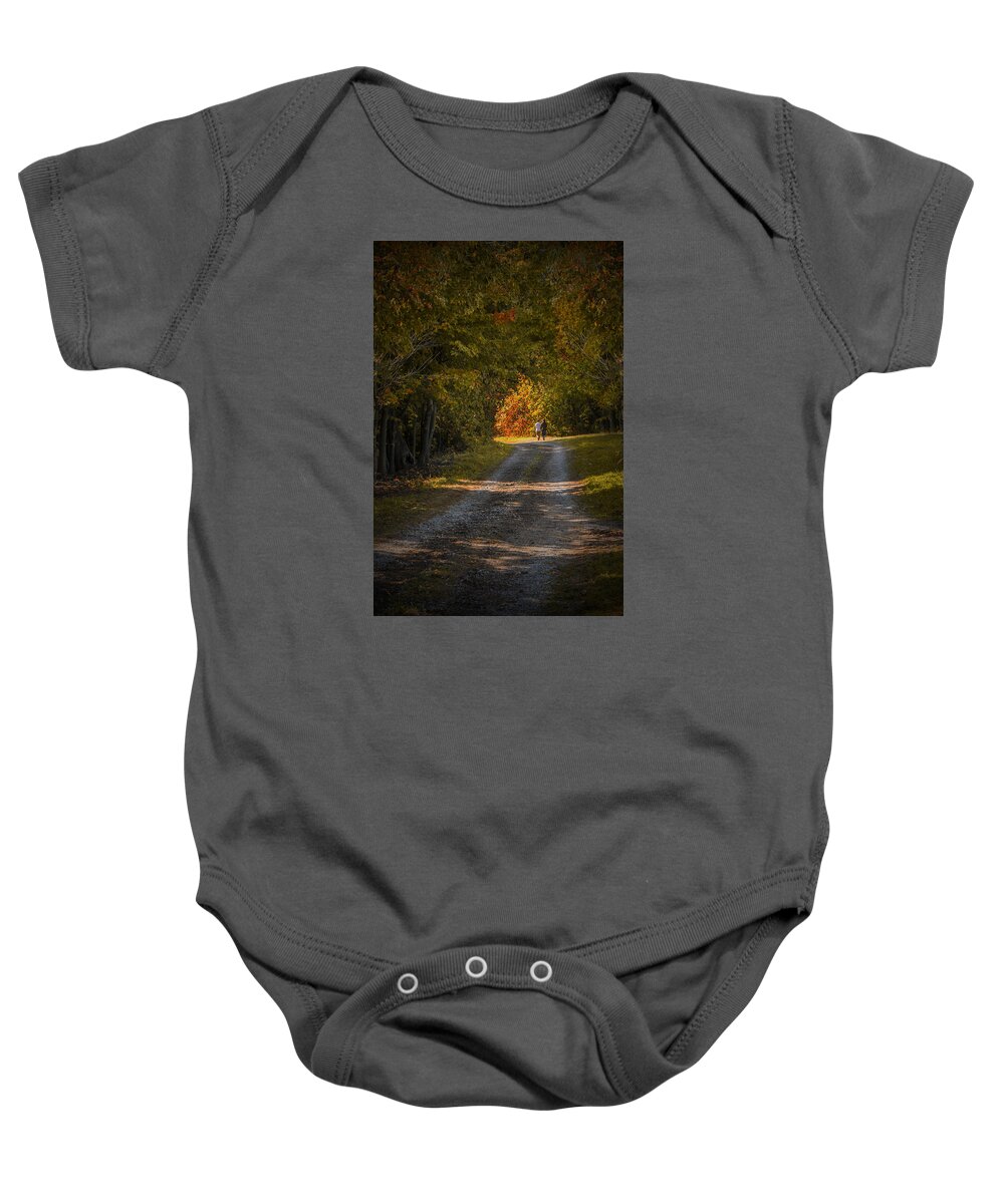 Art Baby Onesie featuring the photograph Couple walking on a Dirt Road through a Tree Canopy during Autumn by Randall Nyhof