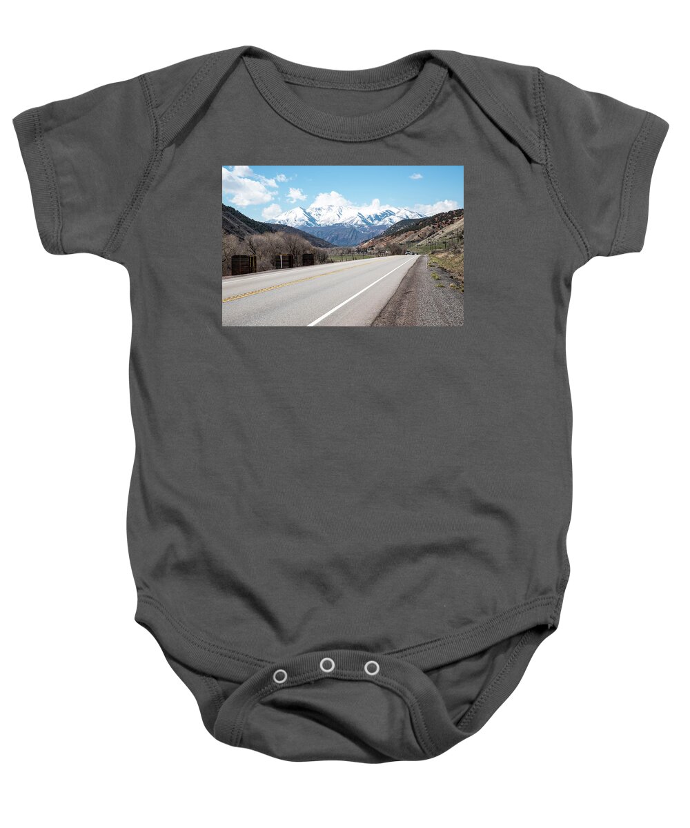 Empty Rail Cars And Us 191 Baby Onesie featuring the photograph Empty Rail Cars and US 191 by Tom Cochran