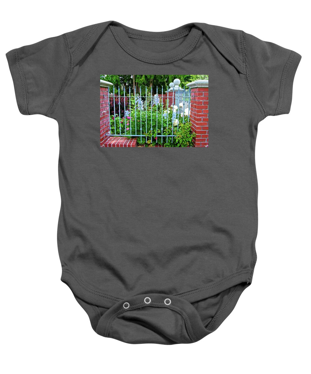 Garden Behind A Fence Along Turn Point Road On San Juan Island Baby Onesie featuring the photograph Garden Behind a Fence along Turn Point Road on San Juan Island, Washington by Ruth Hager