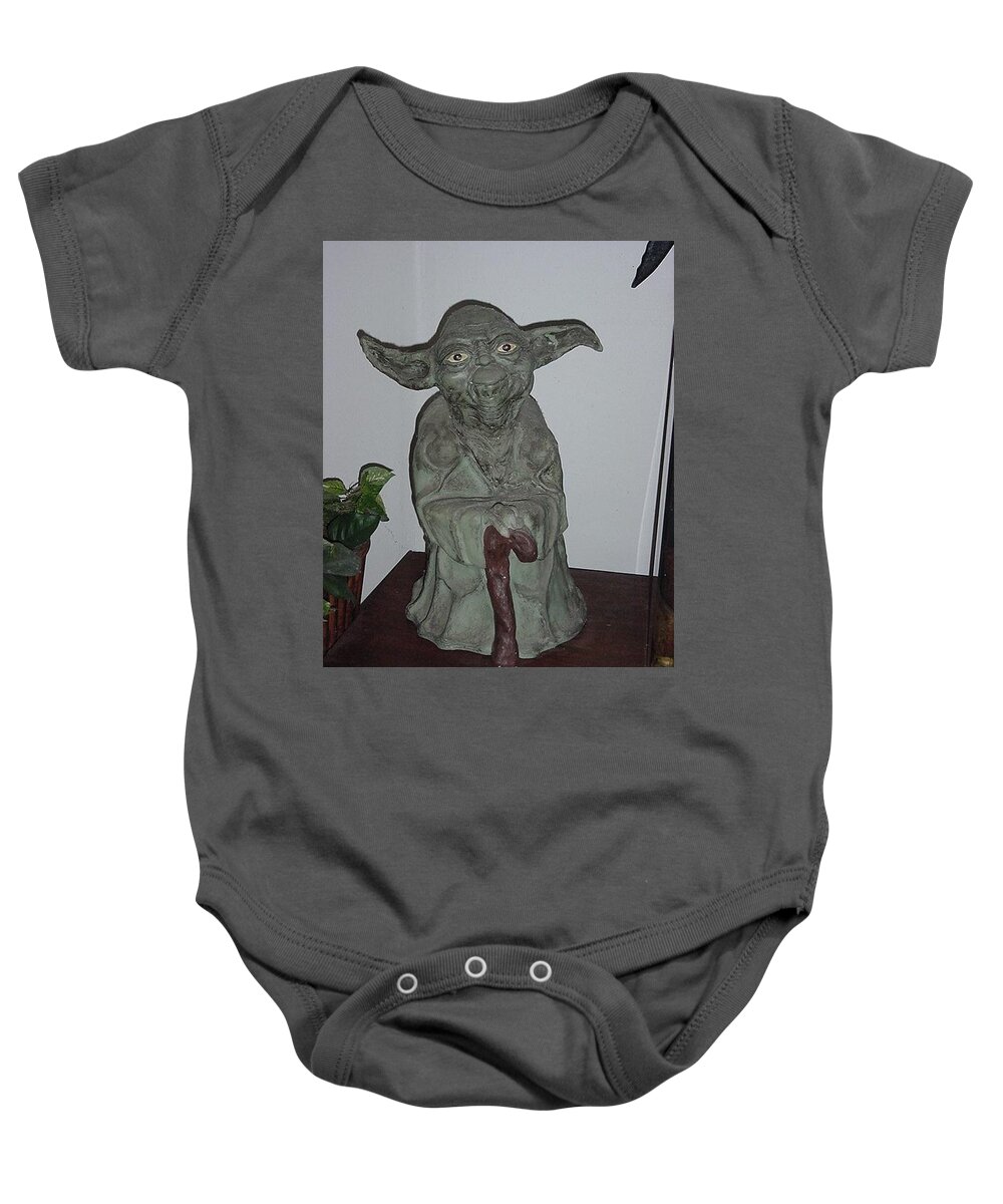 Green Man Baby Onesie featuring the sculpture Green Man by Val Oconnor