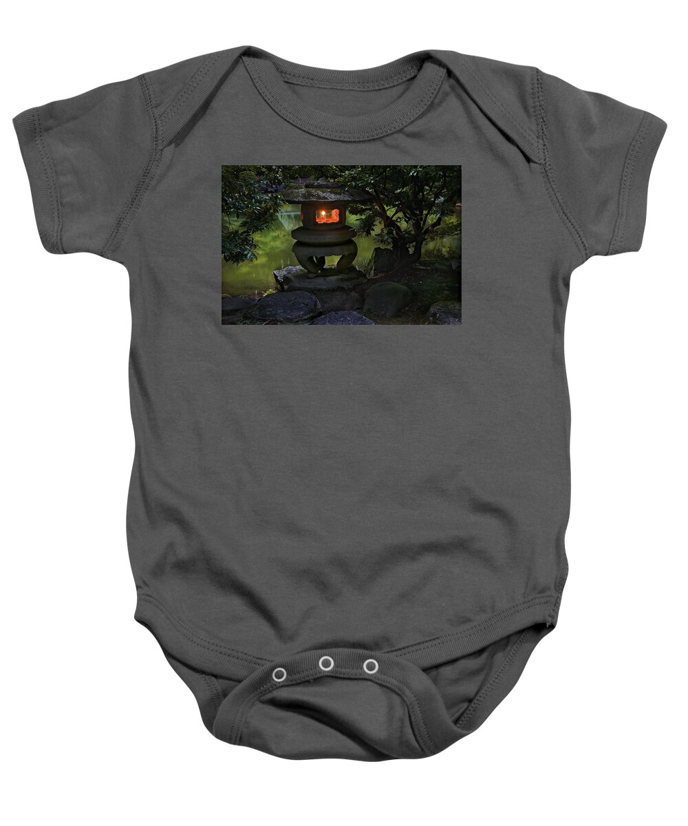 Garden Baby Onesie featuring the photograph Japanese Lantern at the edge of the pond by John Christopher
