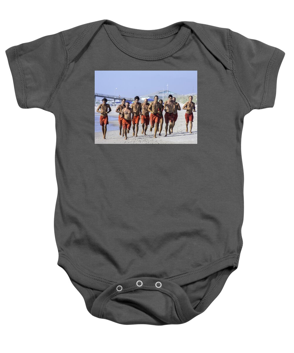  Life Guard Baby Onesie featuring the photograph Kure Beach Life guards on the run by WAZgriffin Digital