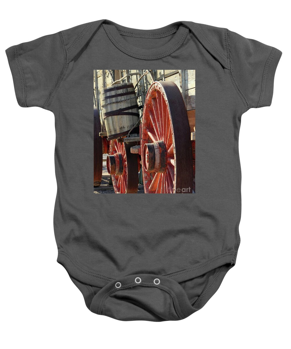 Old Wagon Wheels Baby Onesie featuring the photograph Old Wagon Wheels Death Valley 6409 by Jack Schultz