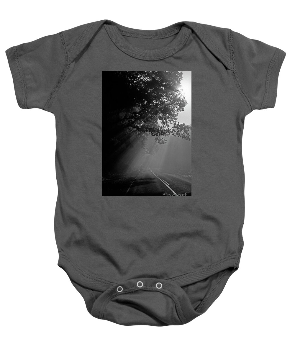 Travel Baby Onesie featuring the photograph Road with Early Morning Fog by Jim Corwin