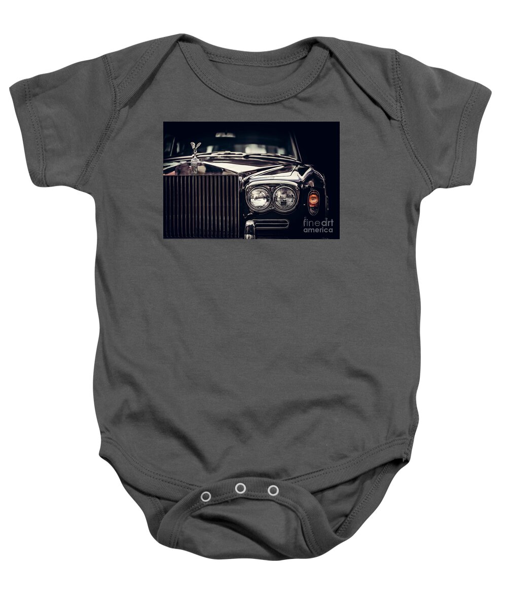 Car Baby Onesie featuring the photograph Rolls-Royce - classic British car on black background, close-up. by Michal Bednarek