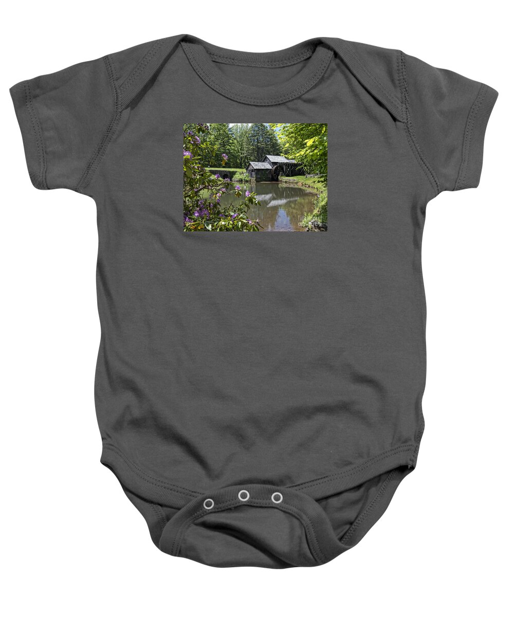 Mabry Baby Onesie featuring the photograph Spring reflections of an Ancient Mill by Brenda Kean