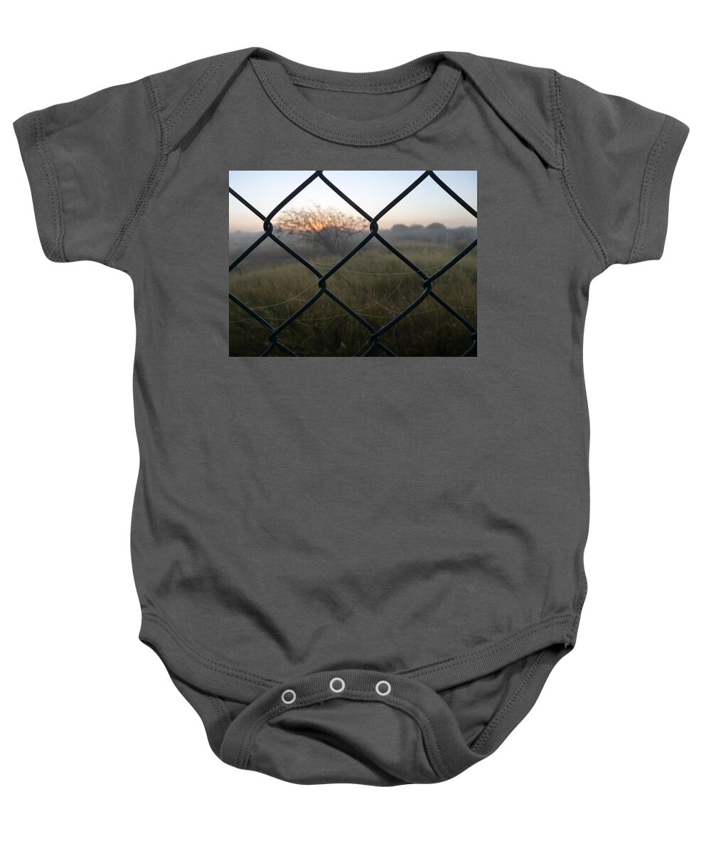 #fence Baby Onesie featuring the photograph The Outlander by Jeremy Holton