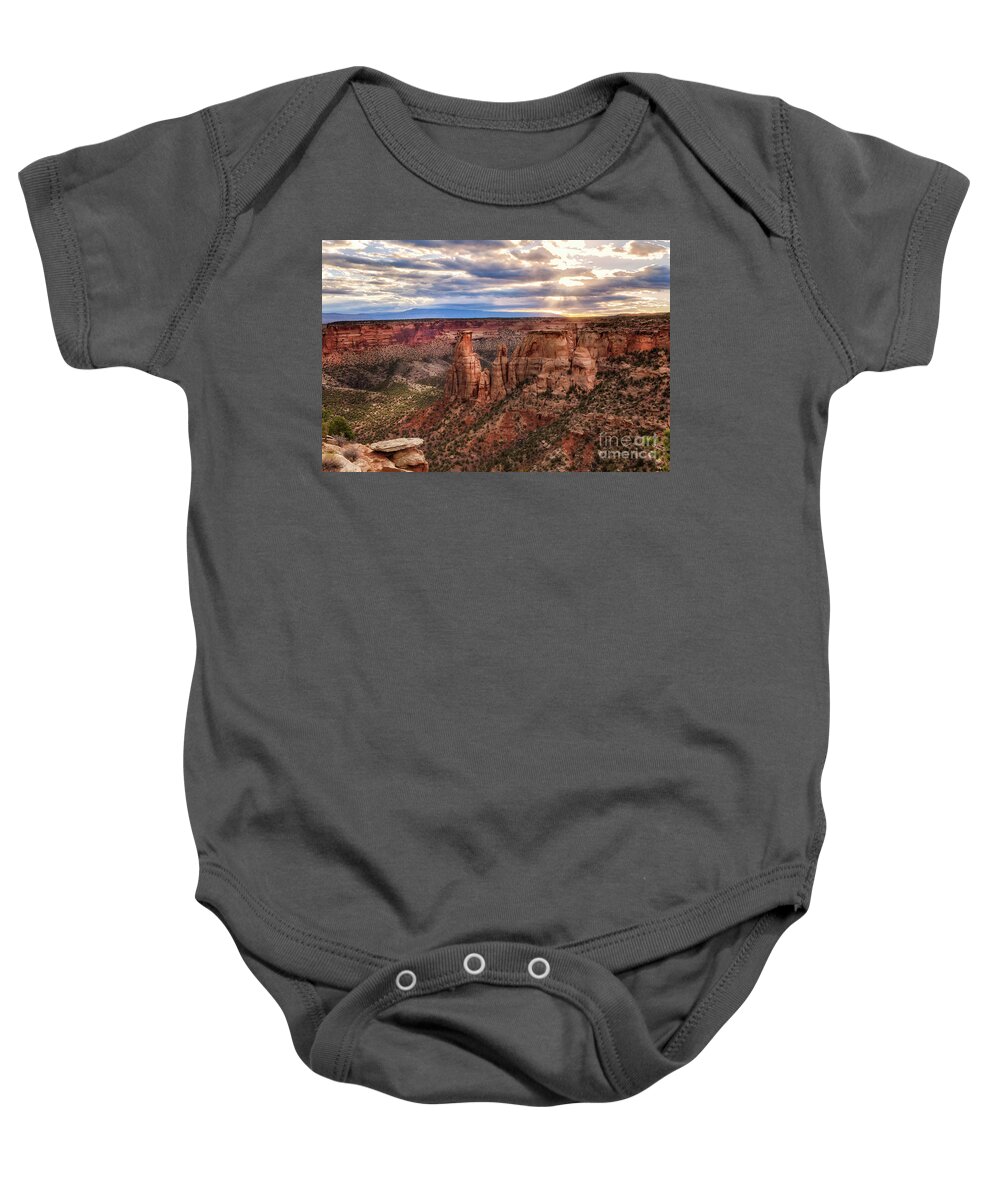Colorado National Monument Baby Onesie featuring the photograph The Sun coming up over the Colorado National Monument by Ronda Kimbrow