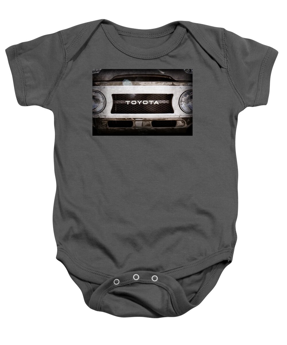 Toyota Land Cruiser Grille Emblem Baby Onesie featuring the photograph Toyota Land Cruiser Grille Emblem -0589ac by Jill Reger