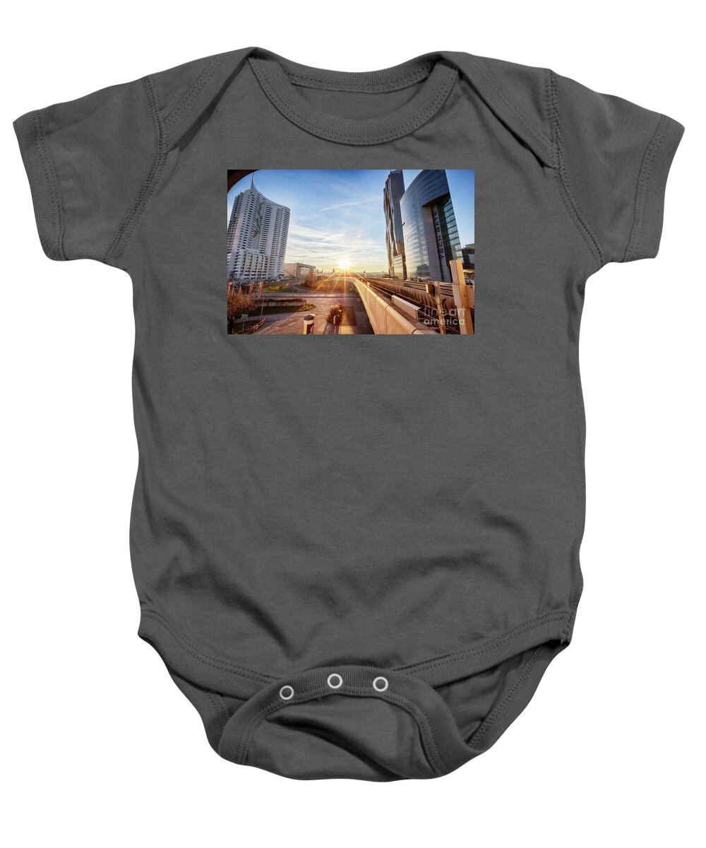 City Baby Onesie featuring the photograph winter sunset near Vienna busness center and metro line by Ariadna De Raadt