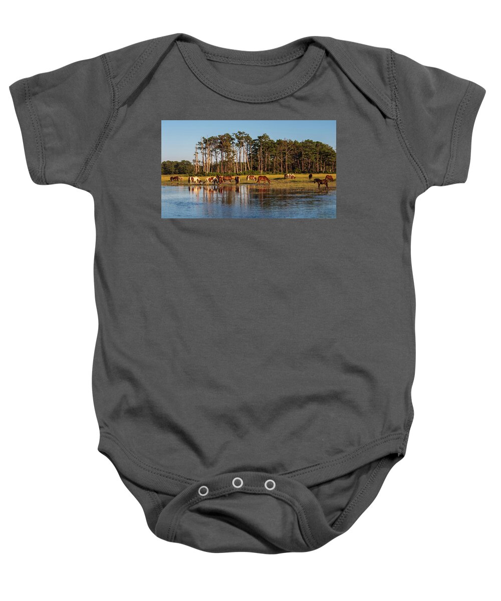 Grass Baby Onesie featuring the photograph chincoteague Island ponies by Louis Dallara