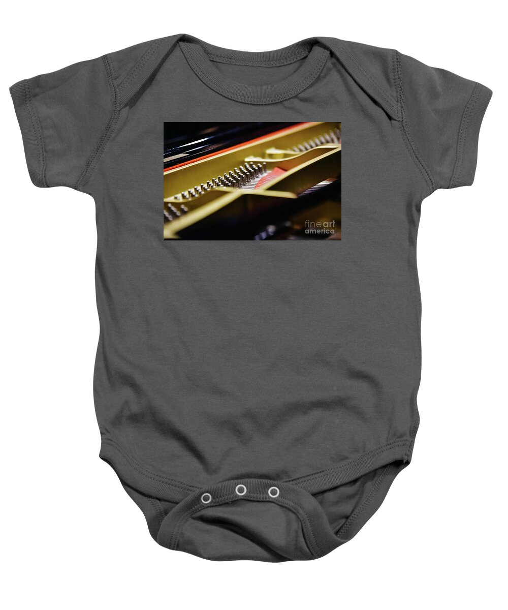 Abstract Baby Onesie featuring the photograph Detail of the interior of a piano with the soundboard, strings and pins. by Joaquin Corbalan