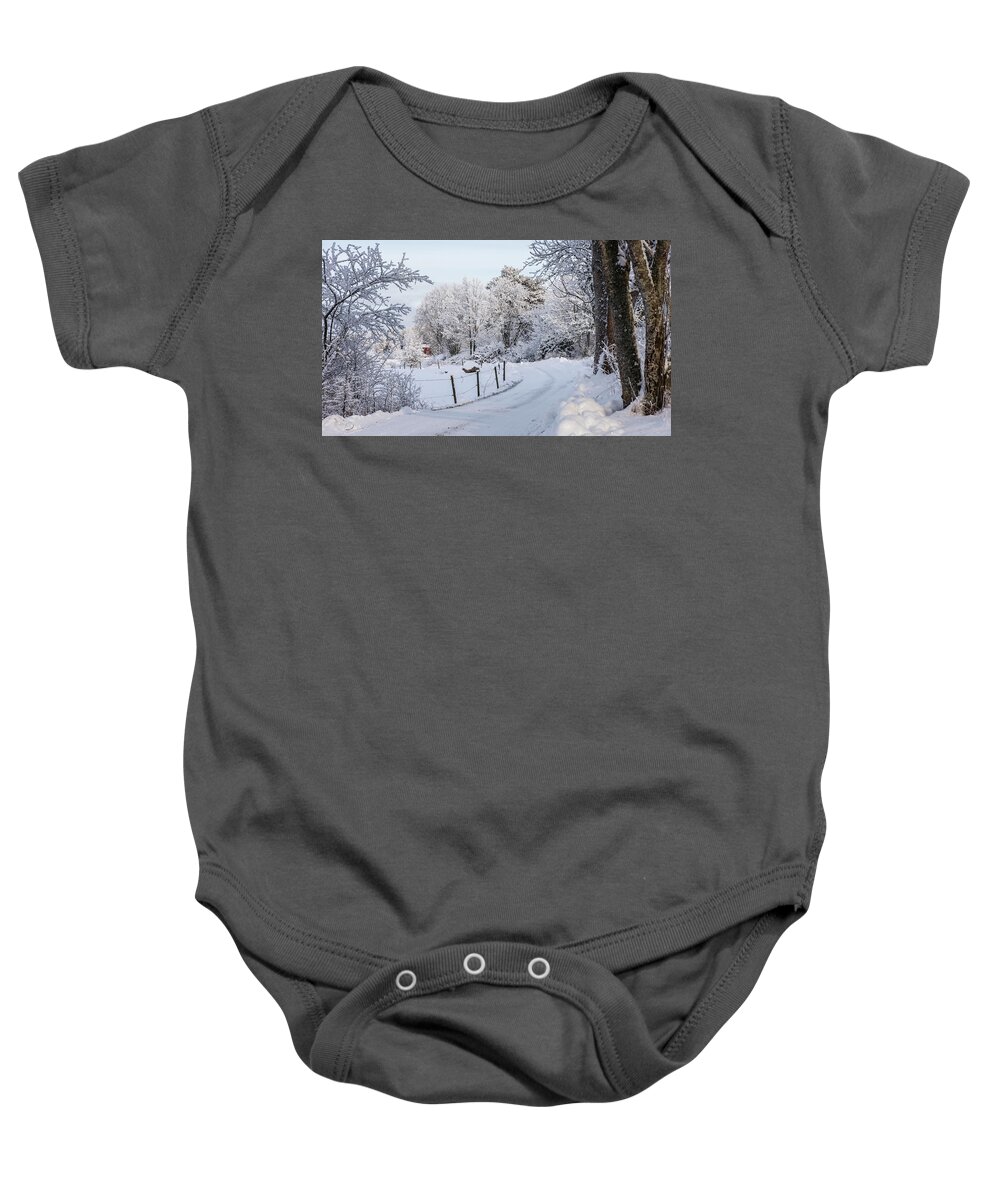 Snowy Gravelled Road Baby Onesie featuring the photograph Gravelled road in winter by Torbjorn Swenelius