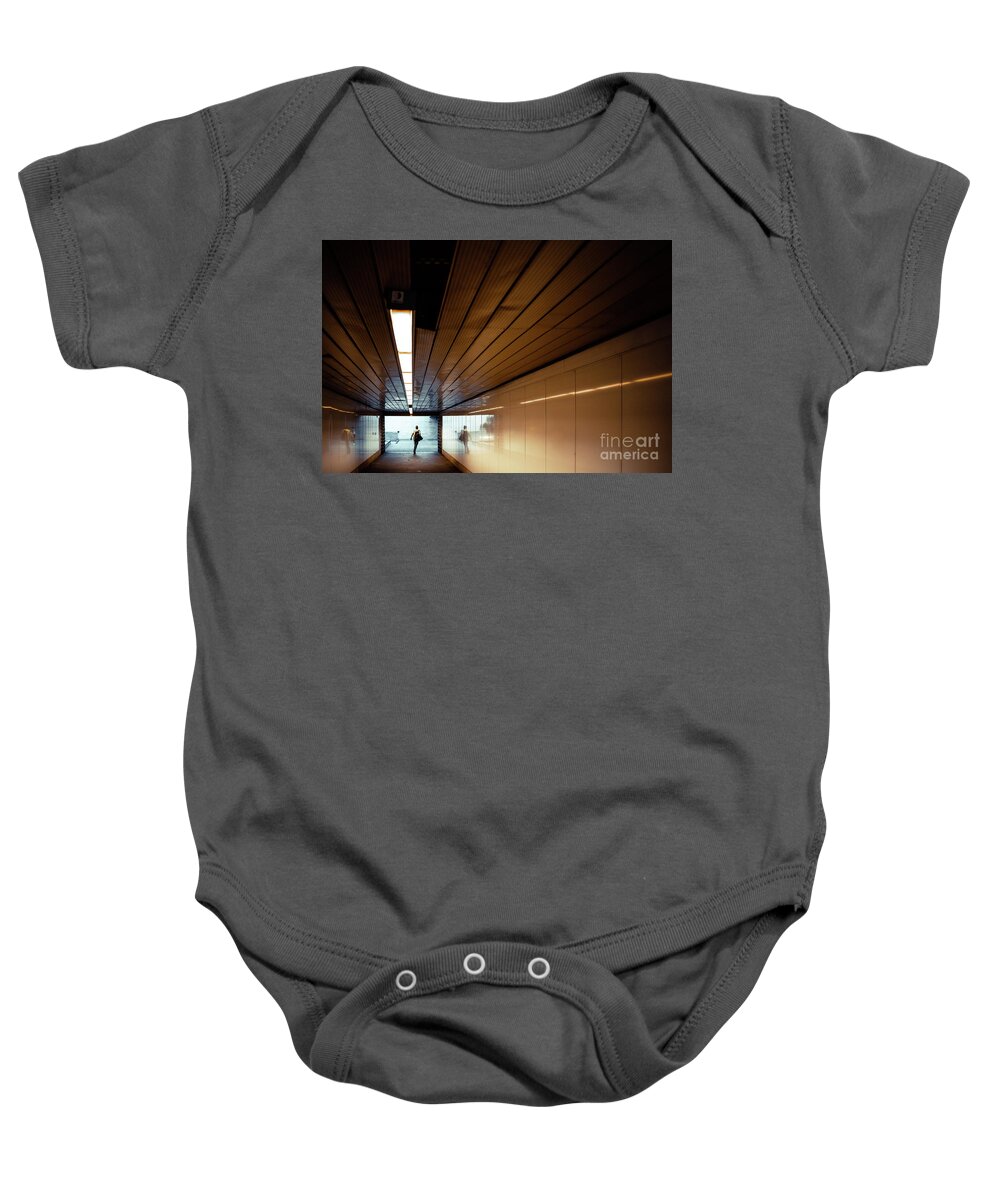 Architecture Baby Onesie featuring the photograph Passengers in a hurry at the end of a tunnel at the entrance to the metro station. by Joaquin Corbalan