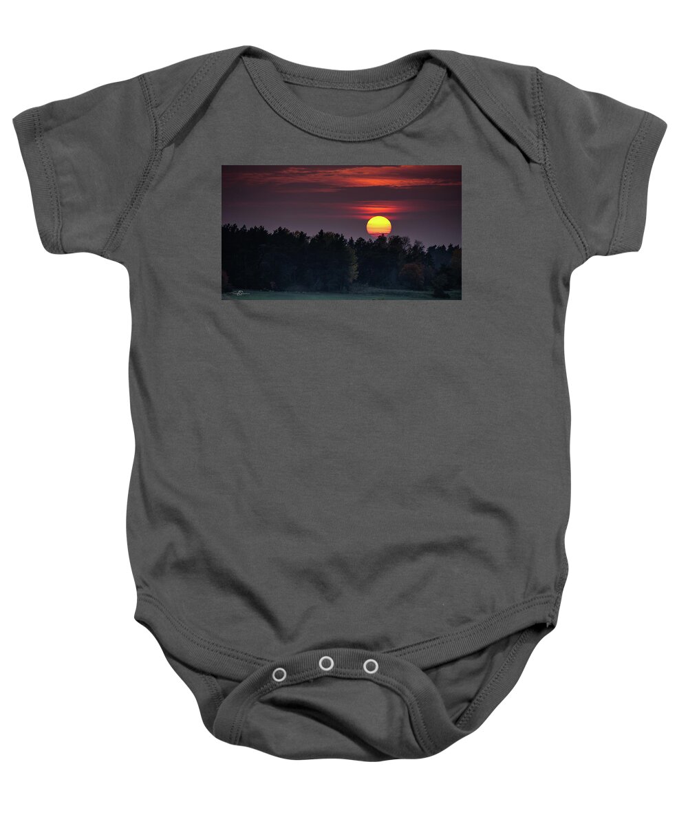 Sunset Baby Onesie featuring the photograph Sunset at an hazy evening by Torbjorn Swenelius