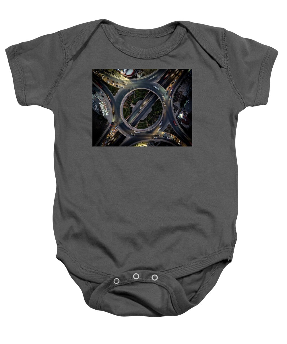 Speed Baby Onesie featuring the photograph Aerial drone top view of a modern motorway junction roundabout with cars moving. Transportation infrastructure, #1 by Michalakis Ppalis