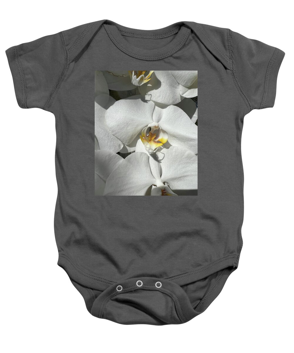 Orchid Baby Onesie featuring the photograph White Orchid With Yellow #1 by Karen Zuk Rosenblatt