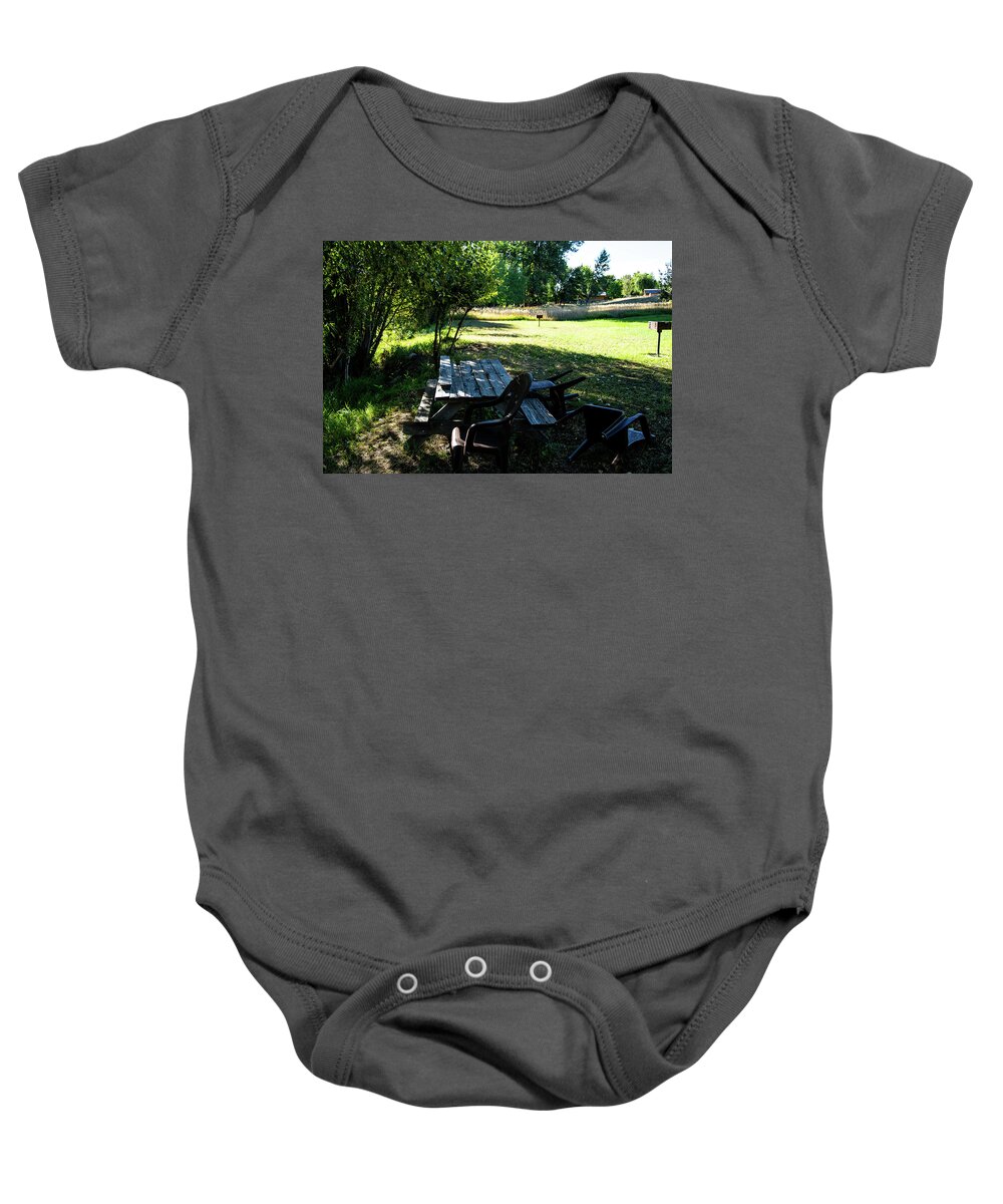 Aging Public Table Baby Onesie featuring the photograph Aging Picnic Table by Tom Cochran