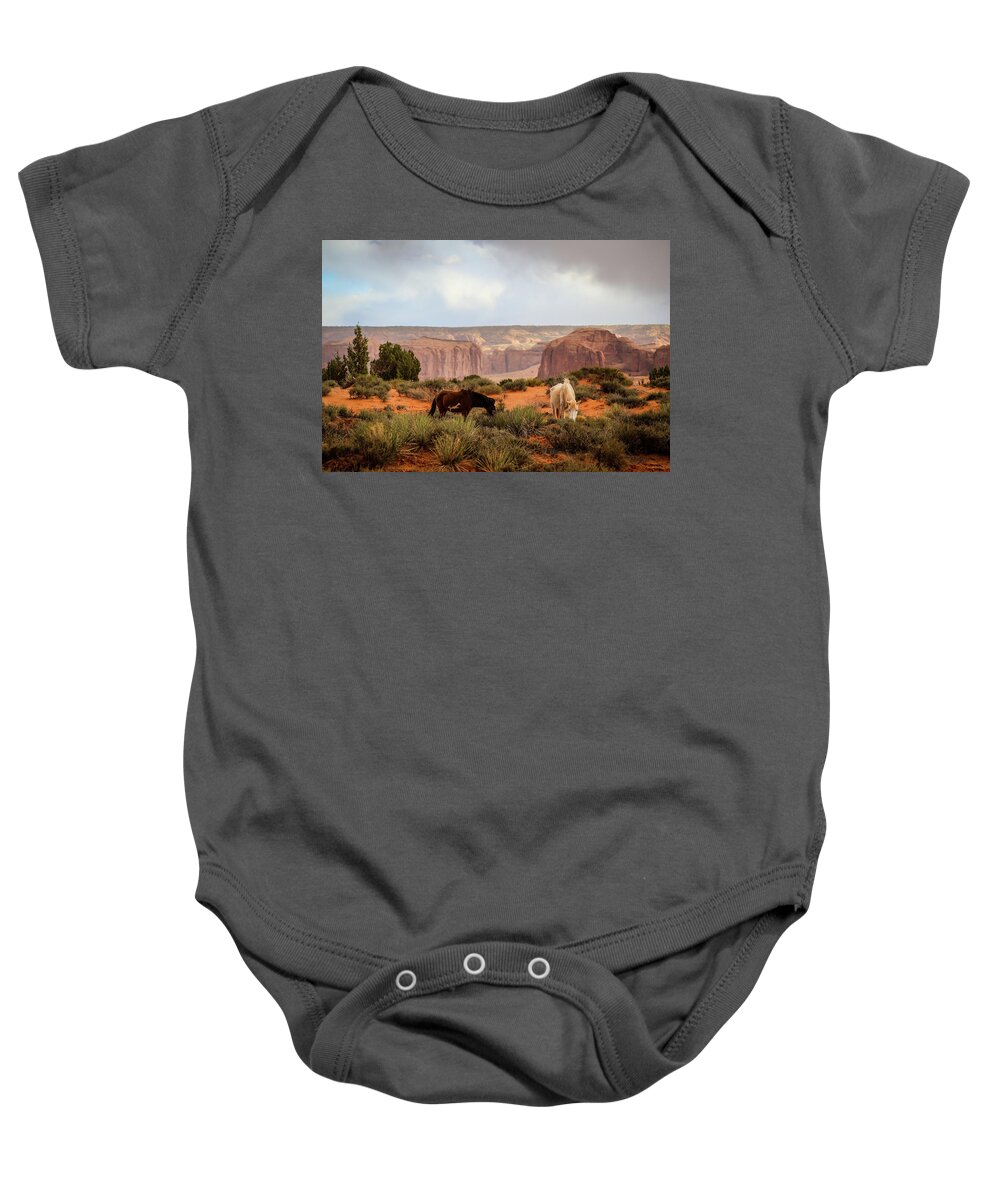 Monument Valley Baby Onesie featuring the photograph Horses in Monument valley by Alberto Zanoni